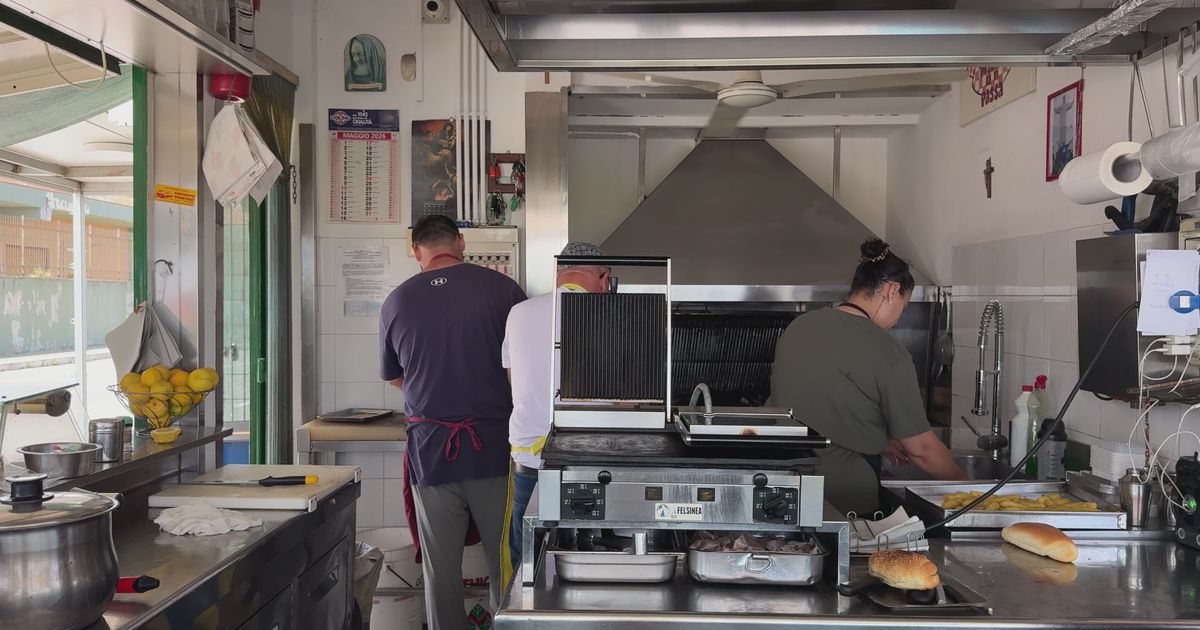 Busy kitchen scene with chefs preparing food